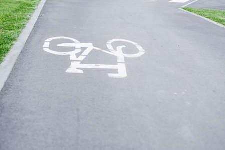 Bicycle path. Bicycle symbol on street. White bicycle sign on asphalt bike lane.の写真素材