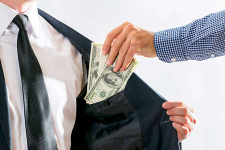 Close-up Of Businessperson is taking bribe from partner. Concept for corruption, finance profit,...