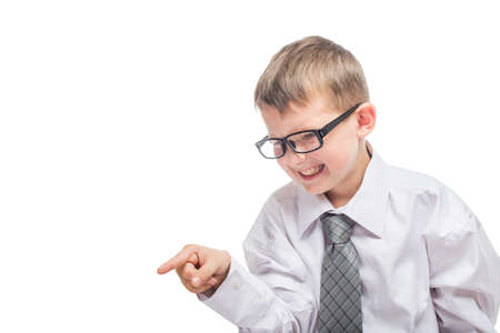 Little cute boy in a shirt and a tie points a finger forward and yells. Angry young businessman is screaming.の写真素材