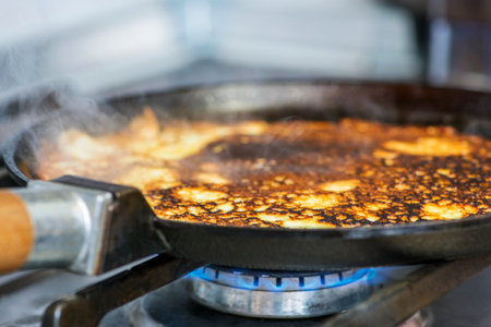 Making pancakes on frying pan. The process of cooking pancakes on a hot frying pan on gas stove range.の写真素材