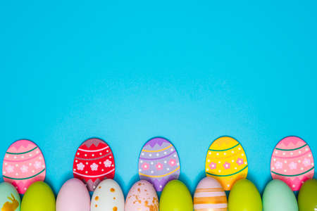 Easter Eggs. Colorful Easter eggs on blue background with copy space. Easter background.の写真素材