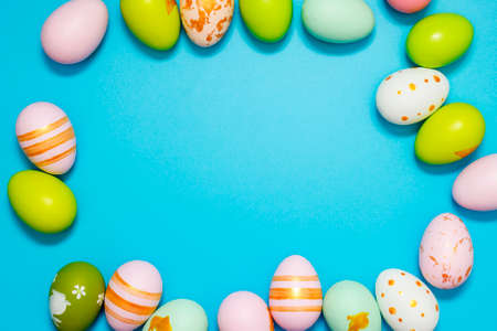 Easter Eggs. Colorful Easter eggs on blue background with copy space.の写真素材