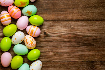 Easter eggs on wooden background. Colorful Easter eggs on a wooden background of boards.の写真素材