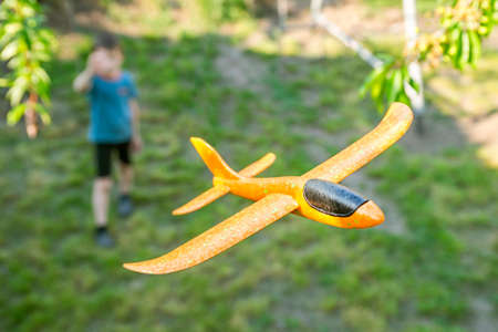 Little boy launches a toy plane into the air. Child launches a toy plane.の写真素材