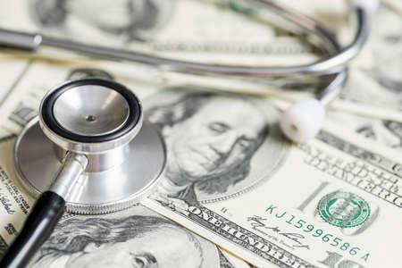 Stethoscope on the dollars. Medical costs. Healthcare payment concept.の写真素材