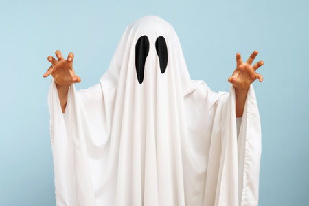 Child dressed up in white costume of scary ghost for Halloweenの写真素材