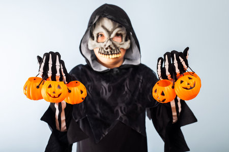 Cute little boy in a costume with many pumpkin baskets jack-o-lanternの写真素材