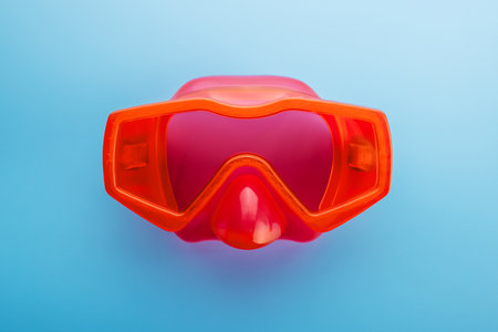 Red swimming mask on a blue background. Mask for diving under waterの写真素材