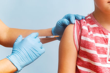 Woman pediatrician doing vaccination of a child. Childhood vaccinationの写真素材