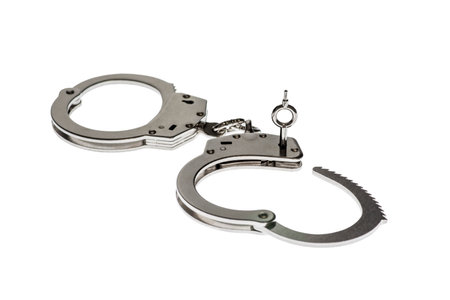 Pair of steel handcuffs isolated on white background. Silver metal handcuffの写真素材