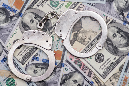 Handcuffs on money background. Dollar bills, money cash corruptionの写真素材