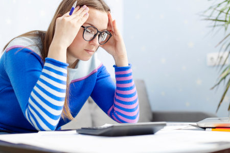 Woman manage household finances frustrated with family financial problemsの写真素材