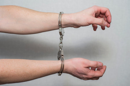 Hands in handcuffs. Prisoner or arrested man ,closeup of hands in handcuffsの写真素材