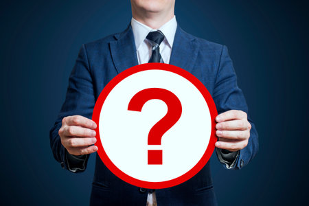 Businessman holding a poster question mark