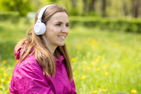 Beautiful young woman likes to listen to music with headphonesの写真素材