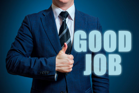Businessman showing thumbs up for the phrase Good Jobの写真素材