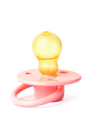 Orthodontic pacifier isolated on white. Pink baby pacifier on white background