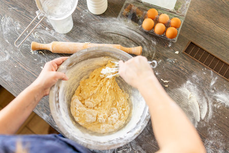 Baking concept. Woman in apron kneading dough for homemade pastries in kitchen