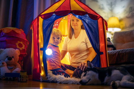 Happy loving family. Mother and her son boy play in children room at bedtimeの写真素材