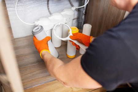 Plumber installs or change water filter. Replacement aqua filterの写真素材