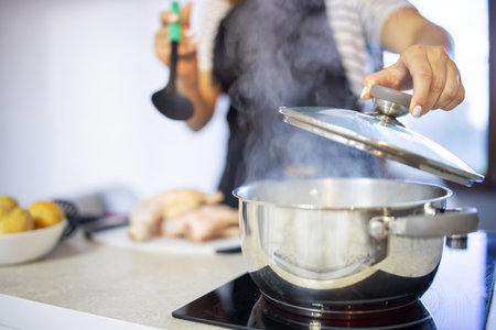 Young woman is cooking in the kitchen. Healthy eating. Healthy lifestyle.の写真素材