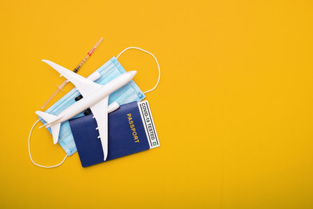 Syringe, toy plane, medical mask and passport with Covid-19 testの写真素材