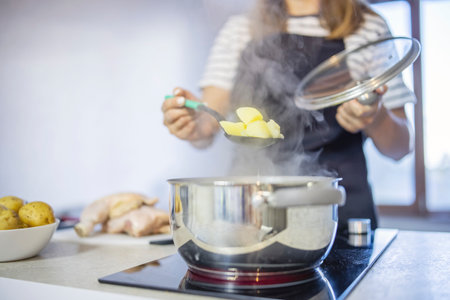 Young woman is cooking in the kitchen. Healthy eating. Healthy lifestyle.の写真素材