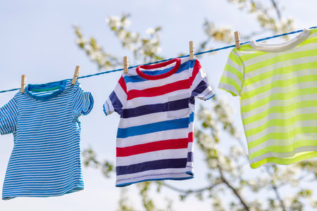 Clean clothes on rope outdoors on laundry day.の写真素材