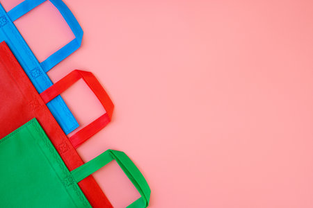 Colorful shopping bags on pink background. Mockup for designの写真素材
