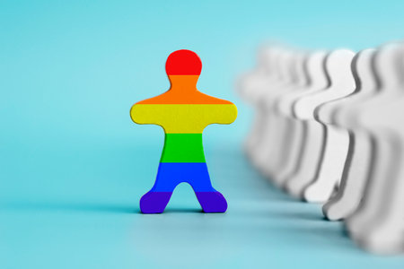 A lot of white figurines and one colored figurine as symbol of diversityの写真素材