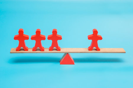 Human figurine has equal weight against a group of people.の写真素材