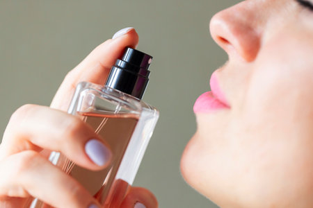 Woman Applying Perfume from a Glass Bottle