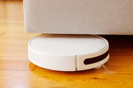 Autonomous Robotic Vacuum Cleaner in Actionの写真素材