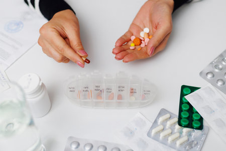 Organized Daily Medication on White Backgroundの写真素材