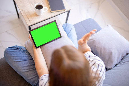 Person with Tablet on Green Screenの写真素材