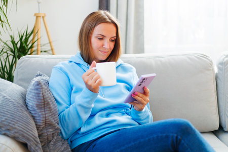 Woman Enjoying Morning Coffee and Smartphoneの写真素材