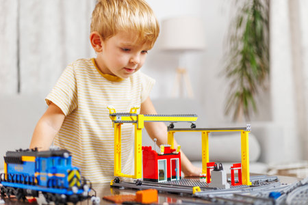 Boy Playing with Toy Train and Construction Setの写真素材