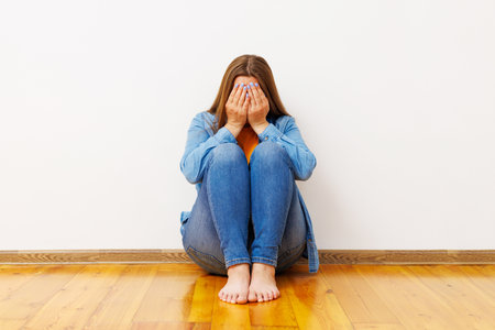 Woman Sitting on Floor Feeling Upsetの写真素材
