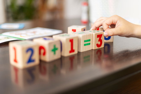 Child arranging number blocks for mathの写真素材