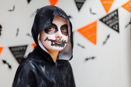 Child in Halloween Costume with Face Paintの写真素材