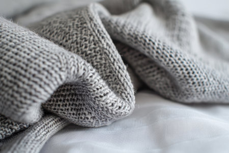 A professional studio shot showcasing a heather grey sweatshirt, its detailed stitching and textured fabric, set against a seamless white background. ideal for fashion catalogs, design presentations, and textile promotions.の素材