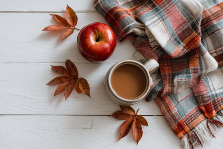 Autumn Flat Lay with Caramel Apple, Mug, Plaid Napkin, and Leavesの素材