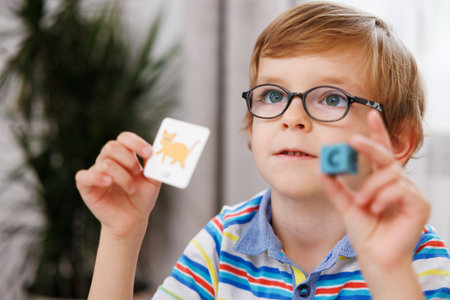 Young Boy Learning with Flashcards and Alphabet Blocks