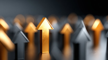 A bright golden arrow stands out among gray arrows, symbolizing leadership and ambition. The image features a soft bokeh background, metallic texture, and dramatic studio lighting.の素材