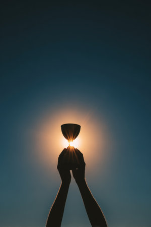 Silhouetted hands release a trophy into the air against a bright sun, symbolizing freedom and victory. The minimalist artistic style enhances the powerful imagery of triumph.の素材