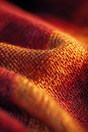 Close-up macro image of fabric with visible threads, glowing in sunlight. The warm tones and detailed texture create a realistic and vibrant visual effect.の素材