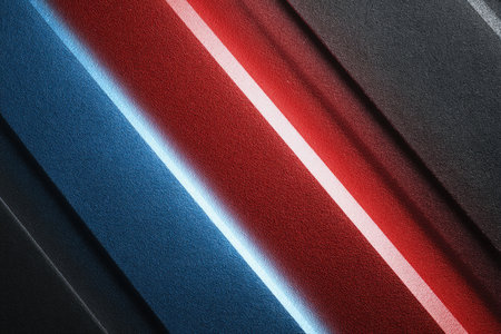 Abstract design featuring diagonal metallic lines in red, white, and blue on a dark matte surface. The sleek and professional look adds a modern touch to any project.の素材