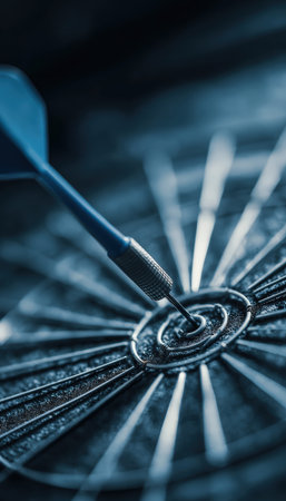 Macro image of a blue dart embedded in a bullseye, showcasing precision. The shallow depth of field and soft tones emphasize focus and accuracy, ideal for themes of success.の素材