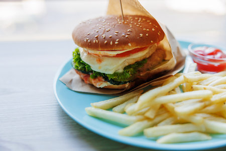Delicious Cheeseburger with Fries on a Blue Plate