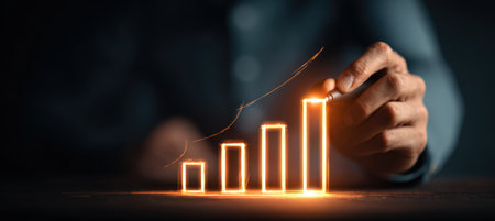 A person draws a glowing, rising bar graph symbolizing financial progress. The image features a dark, elegant background with cinematic HDR photography for dramatic effect.の素材
